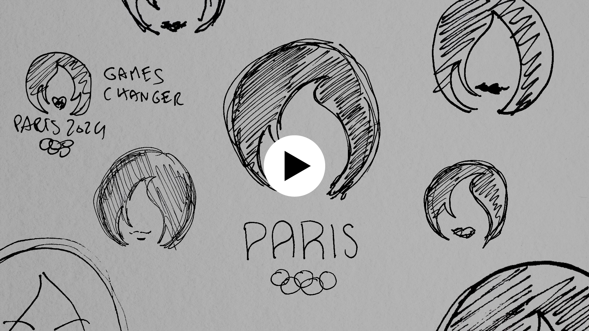 Capture de la vidéo : mise en scène des dessins préparatoires du logo de Paris 2024. Icône play en surimpression indiquant que l'image est cliquable et mène vers un contenu vidéo.